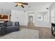 Bright living room with wood floors, open floor plan, and a glimpse into other areas of the home at 11142 E Ravenna Ave, Mesa, AZ 85212