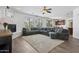Spacious living room with fireplace, large windows, and an open floor plan leading into the kitchen area at 11142 E Ravenna Ave, Mesa, AZ 85212