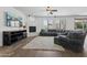 Inviting living room boasts a fireplace, large windows, and a comfortable gray sectional sofa at 11142 E Ravenna Ave, Mesa, AZ 85212