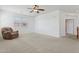 Bright living room with a ceiling fan and comfortable armchair at 11142 E Ravenna Ave, Mesa, AZ 85212