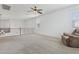 Open loft area with neutral carpet, ceiling fan, and railing at 11142 E Ravenna Ave, Mesa, AZ 85212