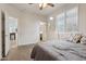 Spacious primary bedroom with wood floors and a view to the kitchen and bath at 11142 E Ravenna Ave, Mesa, AZ 85212