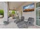 Outdoor seating area with a TV and covered patio at 11142 E Ravenna Ave, Mesa, AZ 85212
