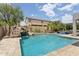 Resort-style pool area features a rock waterfall, slide, and spa for ultimate relaxation and backyard fun at 11142 E Ravenna Ave, Mesa, AZ 85212