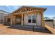 New home construction featuring a wood frame, covered porch, and window awaiting completion at 11417 E Utah Ave, Mesa, AZ 85212