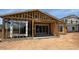 New home under construction with wood framing, sliding glass doors, and ample natural light at 11417 E Utah Ave, Mesa, AZ 85212