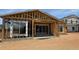 New construction framing highlighting modern sliding doors, window placements, and the overall home structure in progress at 11417 E Utah Ave, Mesa, AZ 85212
