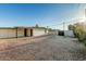 Expansive backyard with gravel, a cinder block fence, and convenient access to the back patio at 1258 E Campus Dr, Tempe, AZ 85282