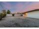 Large backyard featuring a low-maintenance gravel landscape and a covered patio creating a great outdoor space at 1258 E Campus Dr, Tempe, AZ 85282
