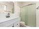 Bright bathroom featuring a modern sink, vanity and a glass-enclosed shower, providing a fresh and clean aesthetic at 1258 E Campus Dr, Tempe, AZ 85282