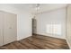 Bedroom features stylish wood flooring, neutral walls, natural light, and a closet for a complete and inviting space at 1258 E Campus Dr, Tempe, AZ 85282