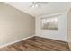 Bedroom features stylish wood flooring, neutral walls, and natural light from the window and ceiling fan to complete the space at 1258 E Campus Dr, Tempe, AZ 85282