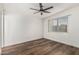Spacious bedroom with wood floors, a ceiling fan, and bright windows at 1258 E Campus Dr, Tempe, AZ 85282