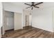 Bedroom with wood floors, modern ceiling fan, and double-door closet at 1258 E Campus Dr, Tempe, AZ 85282