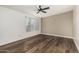 Sunlit bedroom featuring durable wood floors, a ceiling fan, and large windows at 1258 E Campus Dr, Tempe, AZ 85282