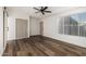 Bright bedroom featuring wood floors, a ceiling fan, closet, and natural light at 1258 E Campus Dr, Tempe, AZ 85282