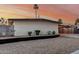 Single-story home features desert landscaping, painted in neutral colors, and a convenient covered parking area at 1258 E Campus Dr, Tempe, AZ 85282