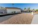 Single-story home features desert landscaping and a convenient covered parking area at 1258 E Campus Dr, Tempe, AZ 85282