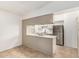 Bright kitchen with stainless steel refrigerator, eat-in bar, and tile flooring at 1258 E Campus Dr, Tempe, AZ 85282
