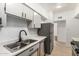 Efficient kitchen layout featuring stainless steel appliances and ample cabinet space, perfect for cooking and storage at 1258 E Campus Dr, Tempe, AZ 85282