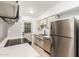 Well-lit kitchen featuring stainless steel appliances, white countertops, and neutral-toned cabinetry at 1258 E Campus Dr, Tempe, AZ 85282