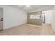 Open living area with tile flooring and view into the kitchen with breakfast bar at 1258 E Campus Dr, Tempe, AZ 85282