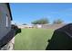 This large backyard features artificial grass and a seating area for outdoor entertainment at 13487 W Buckskin Trl, Peoria, AZ 85383