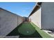 Backyard features artificial grass and a putting green at 13487 W Buckskin Trl, Peoria, AZ 85383