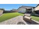 Outdoor living with artificial grass, patio area, and a comfortable armchair at 13487 W Buckskin Trl, Peoria, AZ 85383