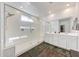 Modern bathroom featuring a large glass shower, double vanity, and stylish wood-look flooring at 13487 W Buckskin Trl, Peoria, AZ 85383