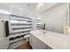 Modern bathroom with gray and white striped shower curtain, large mirror, and white vanity at 13487 W Buckskin Trl, Peoria, AZ 85383