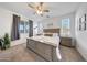 Spacious bedroom features a ceiling fan, soft carpet, and natural light from multiple windows at 13487 W Buckskin Trl, Peoria, AZ 85383