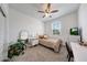 Cozy bedroom with carpet, a ceiling fan, and a bright window for natural light at 13487 W Buckskin Trl, Peoria, AZ 85383