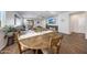 Dining area with modern wood table and chairs, seamlessly flowing into the inviting living space at 13487 W Buckskin Trl, Peoria, AZ 85383