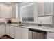 Well-lit kitchen features stainless steel appliances, granite countertops and white cabinets at 13487 W Buckskin Trl, Peoria, AZ 85383
