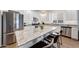 Stylish kitchen featuring granite countertops, stainless steel appliances, and a large center island with seating at 13487 W Buckskin Trl, Peoria, AZ 85383