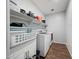 A functional laundry room features tile flooring and a washer and dryer at 13487 W Buckskin Trl, Peoria, AZ 85383