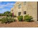 View of backyard space featuring a building exterior with rock landscaping and shrubbery at 13636 N Saguaro Blvd # 103, Fountain Hills, AZ 85268