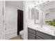 Bathroom boasts modern vanity, framed mirror, and a shower with a dark curtain at 13636 N Saguaro Blvd # 103, Fountain Hills, AZ 85268