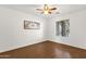 Inviting bedroom with hardwood floors, a ceiling fan, and a window offering natural light at 13636 N Saguaro Blvd # 103, Fountain Hills, AZ 85268