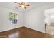 Bright bedroom with ceiling fan, wood floors, and a large window at 13636 N Saguaro Blvd # 103, Fountain Hills, AZ 85268