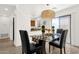 Cozy dining area with a glass table, pendant lighting, and a view of the kitchen at 13636 N Saguaro Blvd # 103, Fountain Hills, AZ 85268