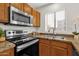Well-equipped kitchen with stainless steel appliances and warm wood cabinetry at 13636 N Saguaro Blvd # 103, Fountain Hills, AZ 85268
