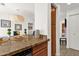 Open-concept kitchen and dining area with eat-in bar and modern lighting at 13636 N Saguaro Blvd # 103, Fountain Hills, AZ 85268