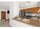 Modern kitchen featuring granite countertops, stainless steel appliances, and a breakfast bar at 13636 N Saguaro Blvd # 103, Fountain Hills, AZ 85268