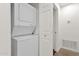 Efficient laundry area featuring a stacked washer and dryer unit for space-saving convenience at 13636 N Saguaro Blvd # 103, Fountain Hills, AZ 85268