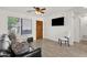 Living room features stylish decor, wood-look tile floors, and ample natural light at 13636 N Saguaro Blvd # 103, Fountain Hills, AZ 85268