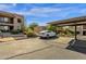 Carport parking with white car and adjacent building with well-maintained landscaping at 13636 N Saguaro Blvd # 103, Fountain Hills, AZ 85268