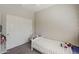 Neutral room with white twin bed, butterfly wall decals, white closet doors, and neutral walls at 1482 S Banning St, Gilbert, AZ 85296