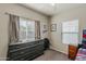 Well-lit bedroom featuring a large window, a dresser with toys, and Buffalo Bills wall decor at 1482 S Banning St, Gilbert, AZ 85296